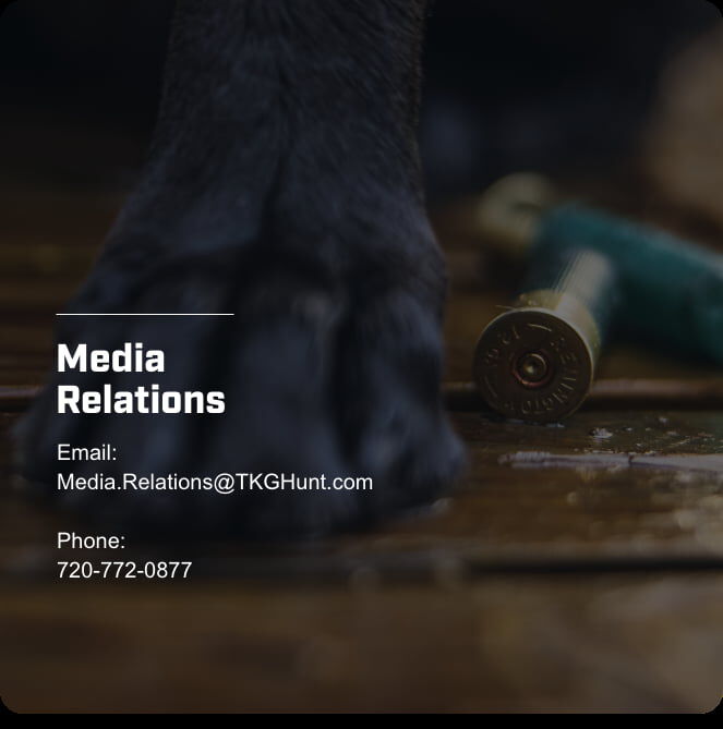 shotshells on the floor with dog paw; Media Relations; Email: Media.Relations@TKGHunt.com; Phone: 720-772-0877