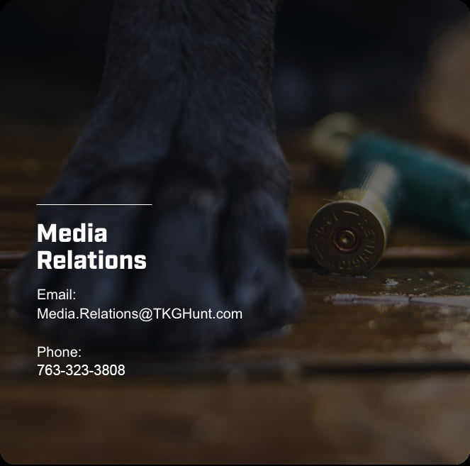 shotshells on the floor with dog paw; Media Relations; Email: Media.Relations@TKGHunt.com; Phone: 763-323-3808