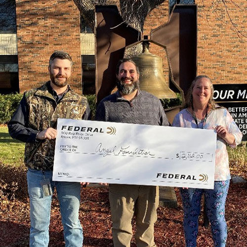 Jared Kutney (Federal), Jim Thrubis (Angel Foundation), and Nellie Simpson (Federal) holding angel foundation check