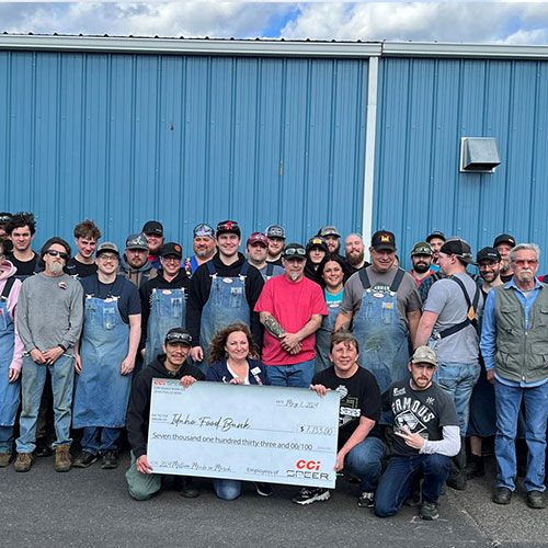 CCI/Speer employees standing outside with a fundraiser check