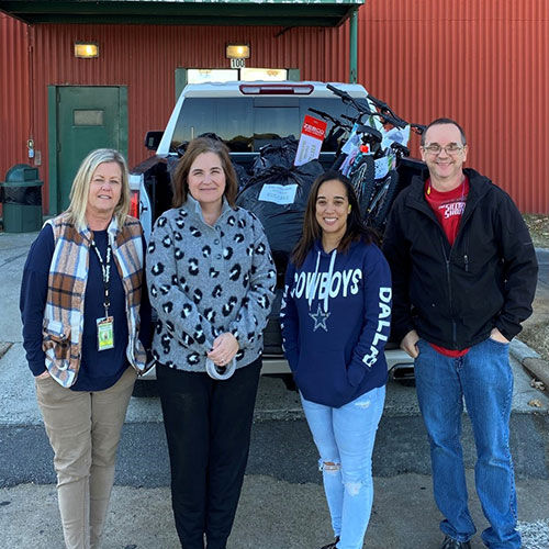 Remington employees standing in front of Angel Tree donations